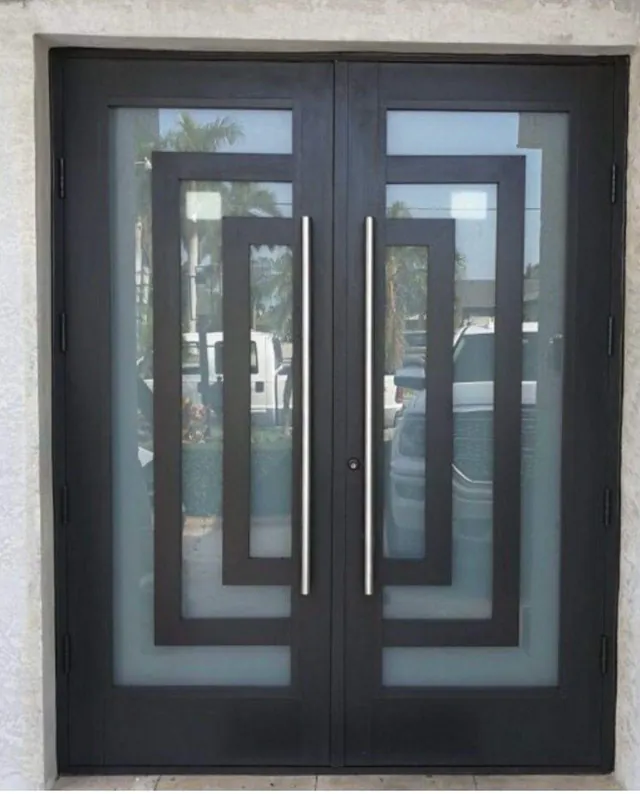 Contemporary dark-frame double impact entry doors with geometric frosted glass inserts and long stainless steel pull handles