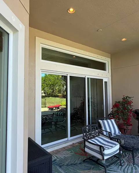 Fixed impact transom window above a sliding glass door on a covered patio in Palm Beach County